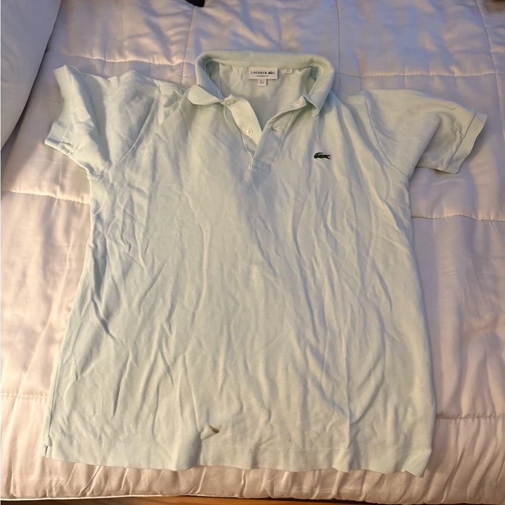 Light blue Lacoste shirt.